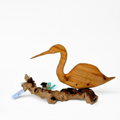 Handcrafted wooden heron sculpture with natural grain, on a gnarled driftwood base. A delicate blue butterfly adds charm for elegant home decor.